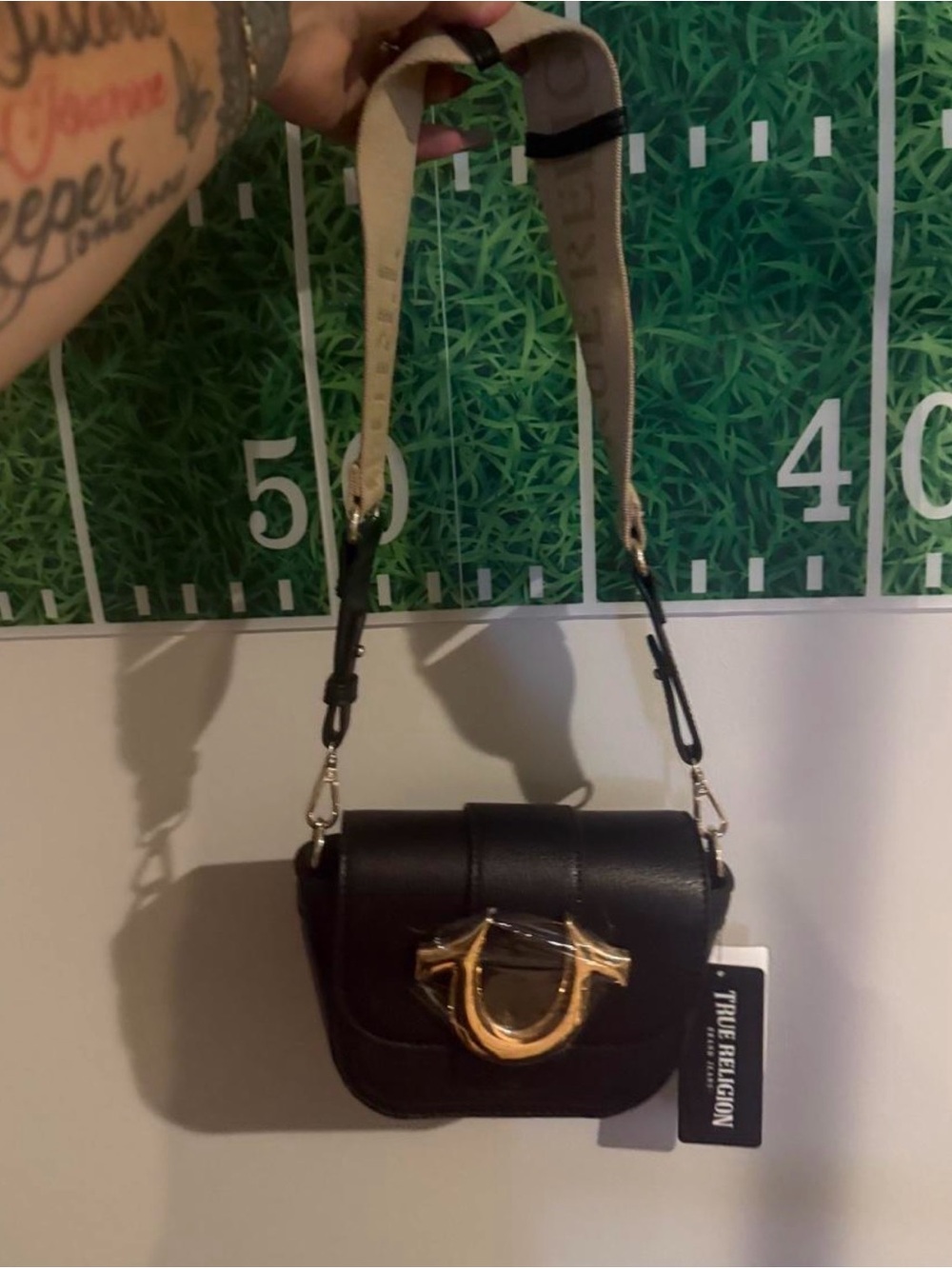 True Religion Black Crossbody Bag with Gold Horseshoe Detail and Beige Strap